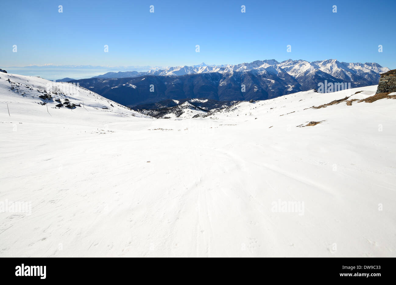 Candid Off-piste Ski Slope In Scenic Background Of Mountain Peaks 