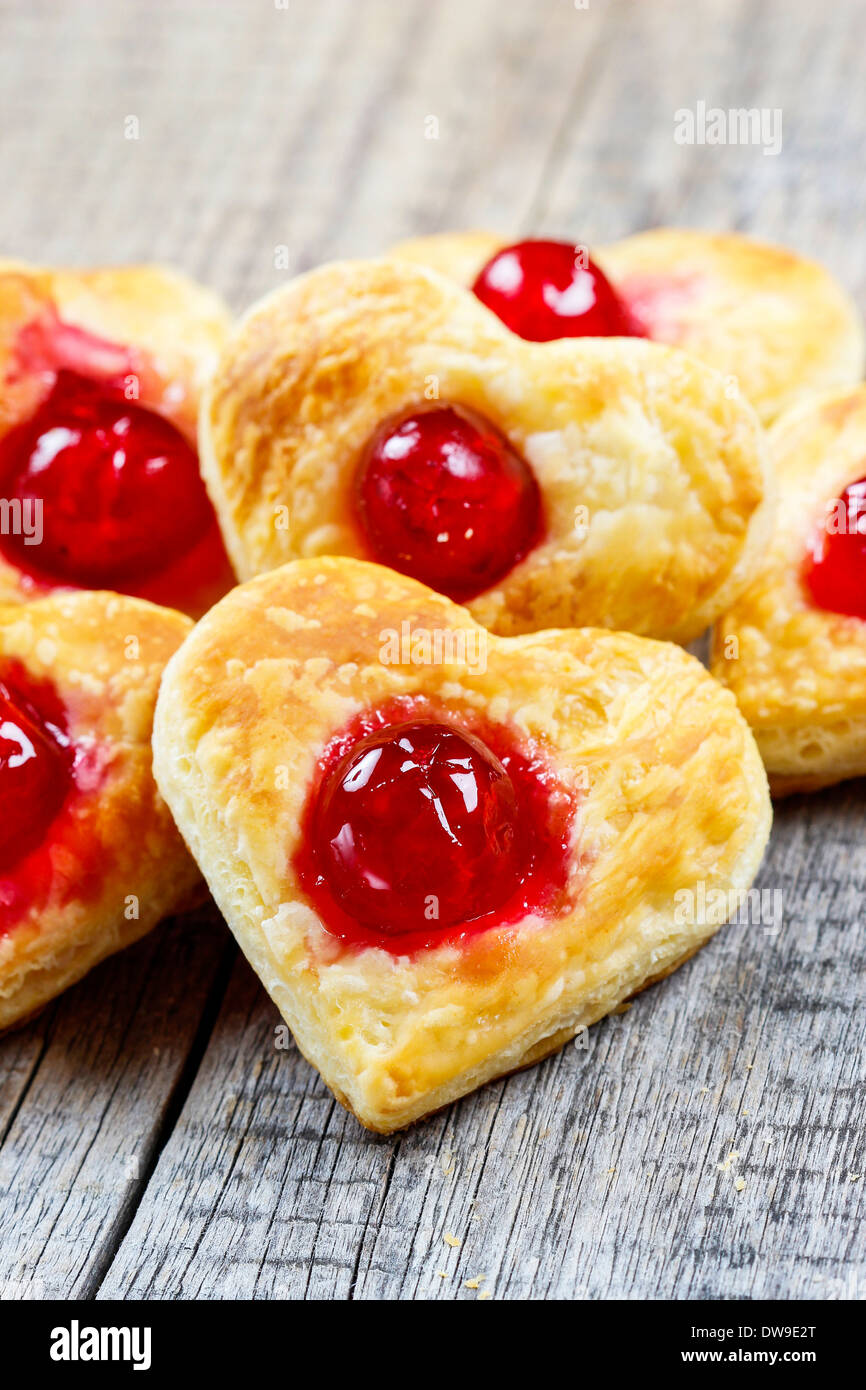 Puff pastry cookies in heart shape filled with cherriesPuff pastry