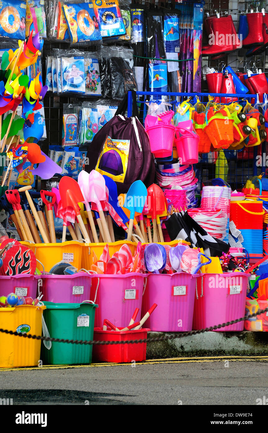 A colourful display in a seaside shop with masses of buckets and spades