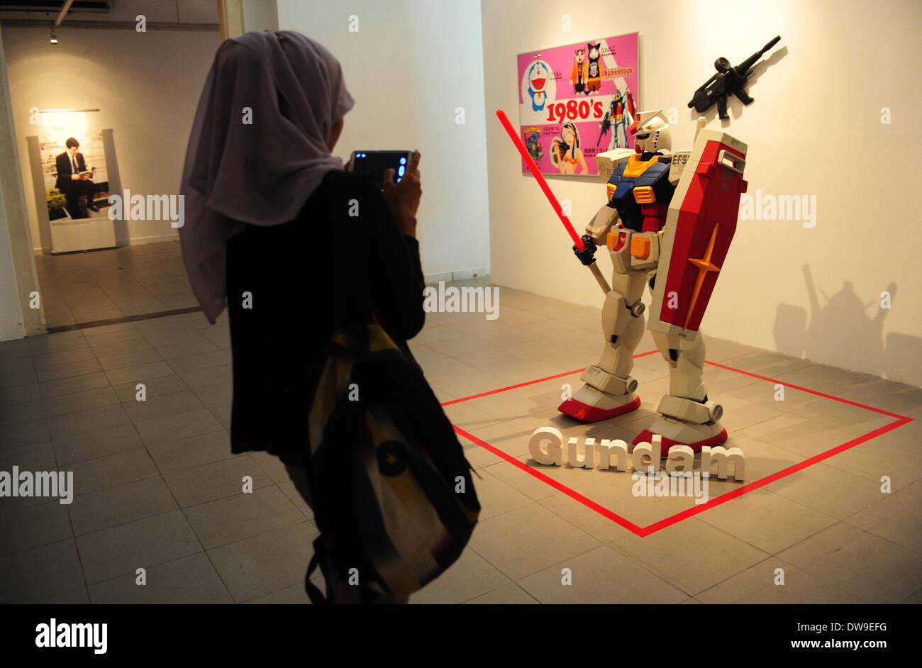 Jakarta, Indonesia. 4th Mar, 2014. A woman takes pictures of a cartoon character during the Japanese Pop Culture Characters Exhibition in Jakarta, Indonesia, March 4, 2014. The exhibition is held from March 4 to March 23. © Zulkarnain/Xinhua/Alamy Live News Stock Photo