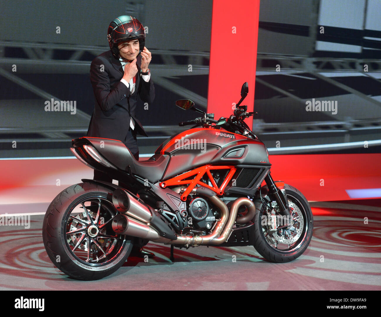 Geneva, Switzerland. 03rd Mar, 2014. CEO of Ducati, Claudio Domenicali,  presents the Ducati Diavel Carbon in the exhibition hall Espace Secheron  during the VW company evening at the eve of the first