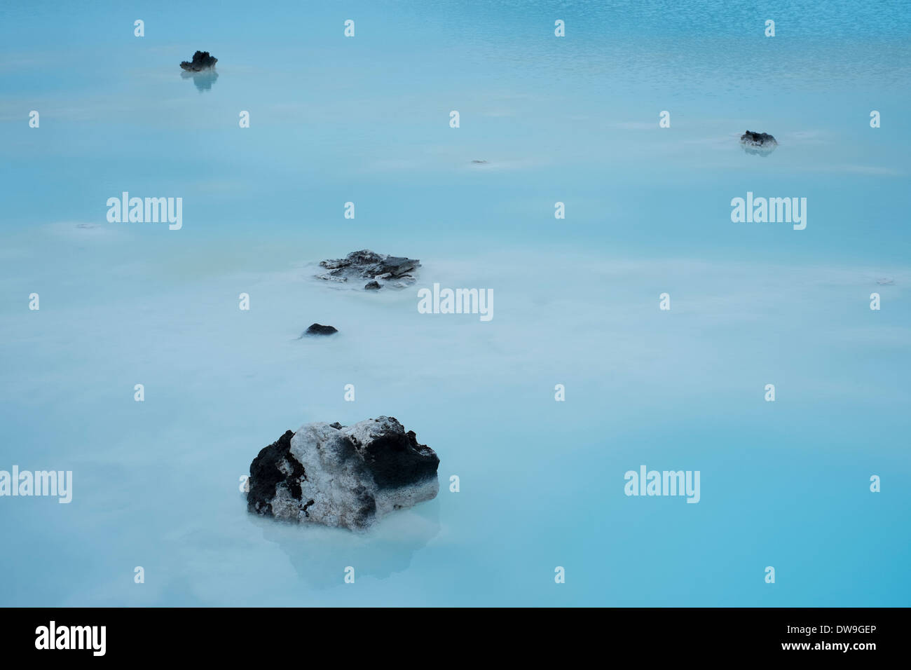 Steam hangs over the blue water from the thermal ponds created by the ...