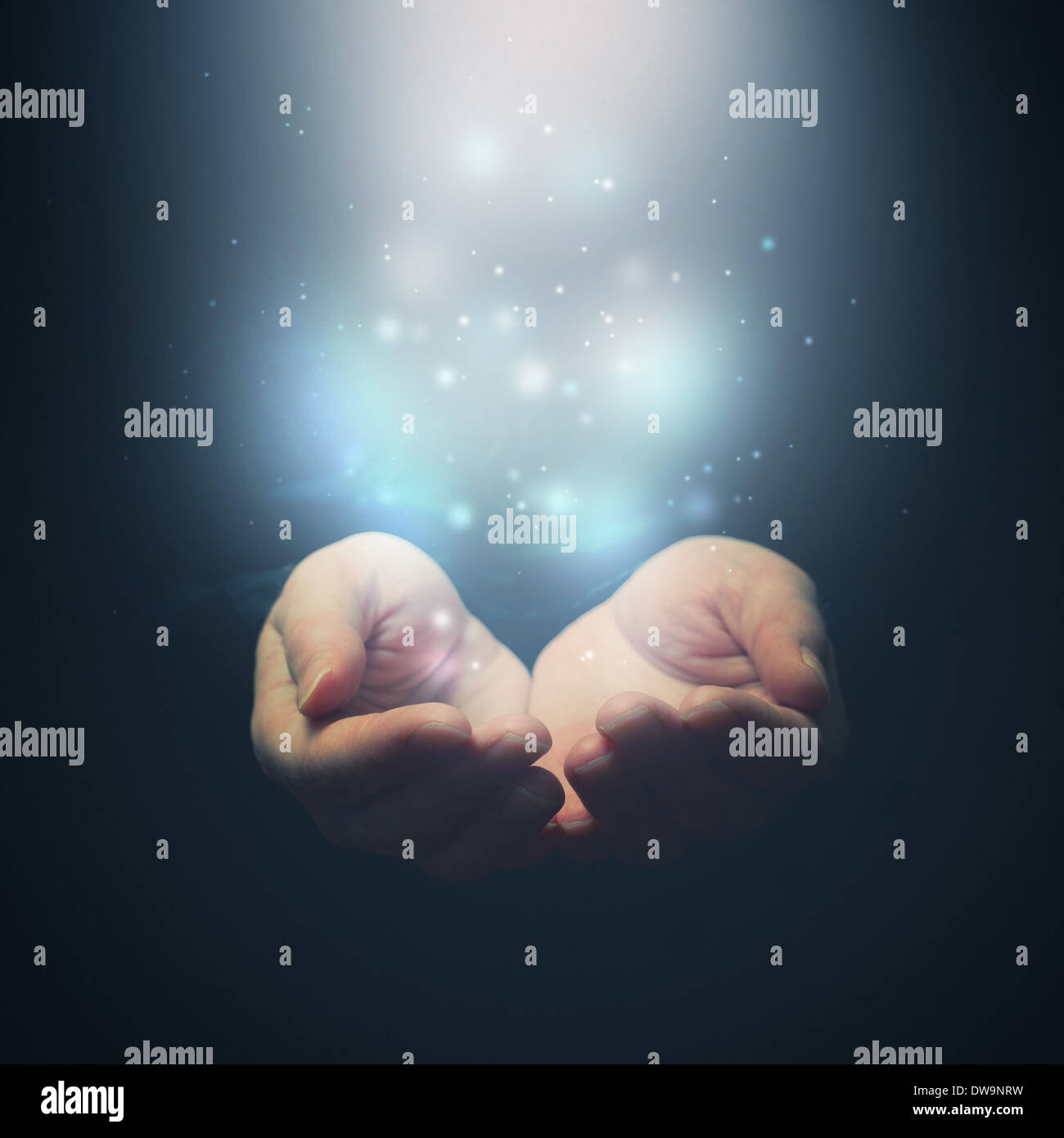 Open hands with magic particles. Holding, giving, showing concept. Selective focus on fingers. Stock Photo