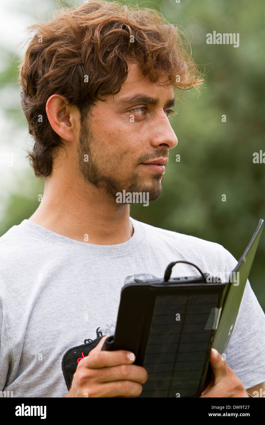 Afghan student using a solar powered tablet Stock Photo