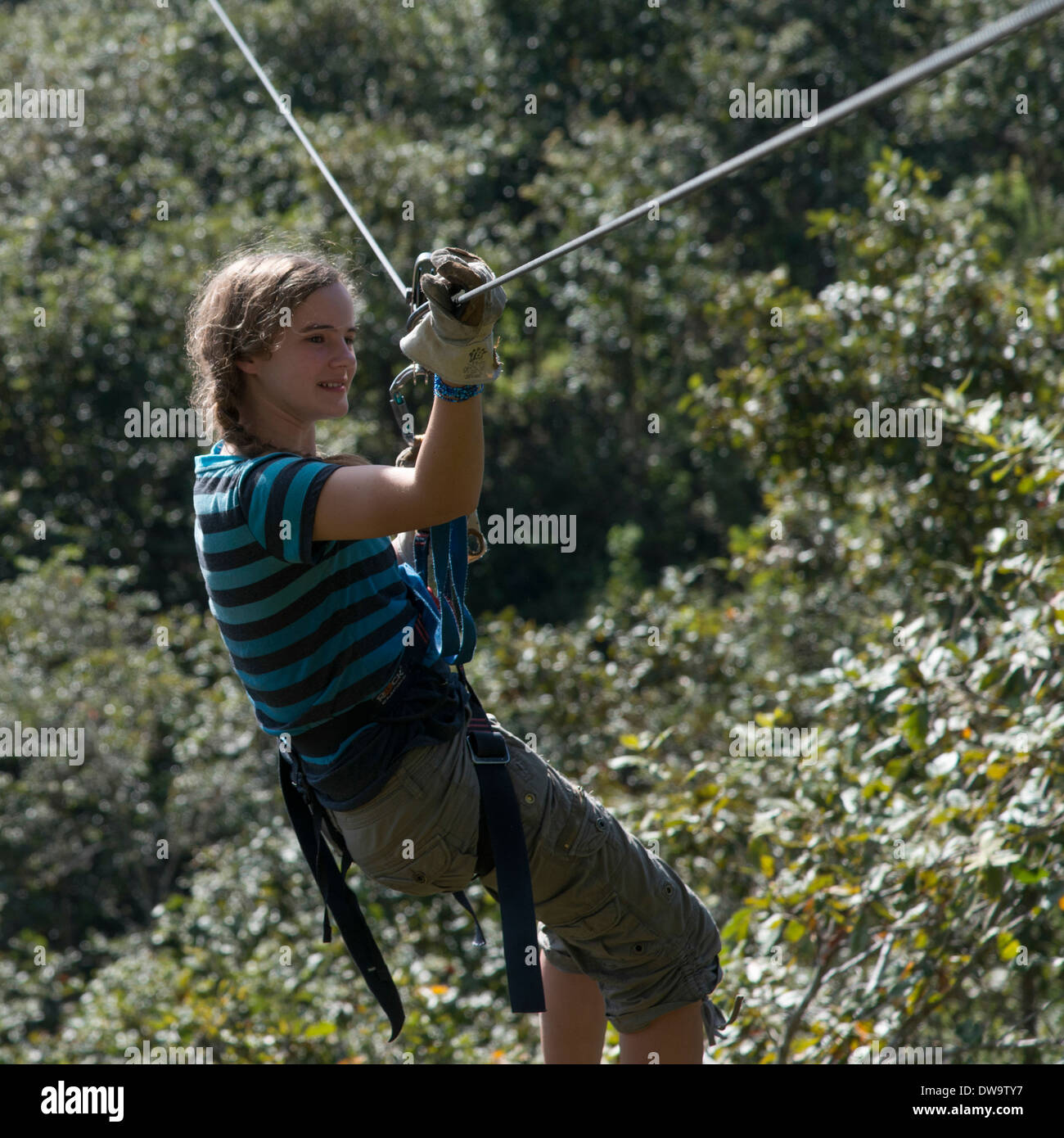 Girl riding a zip line in a forest Copan Copan Ruinas Copan Department Honduras Stock Photo