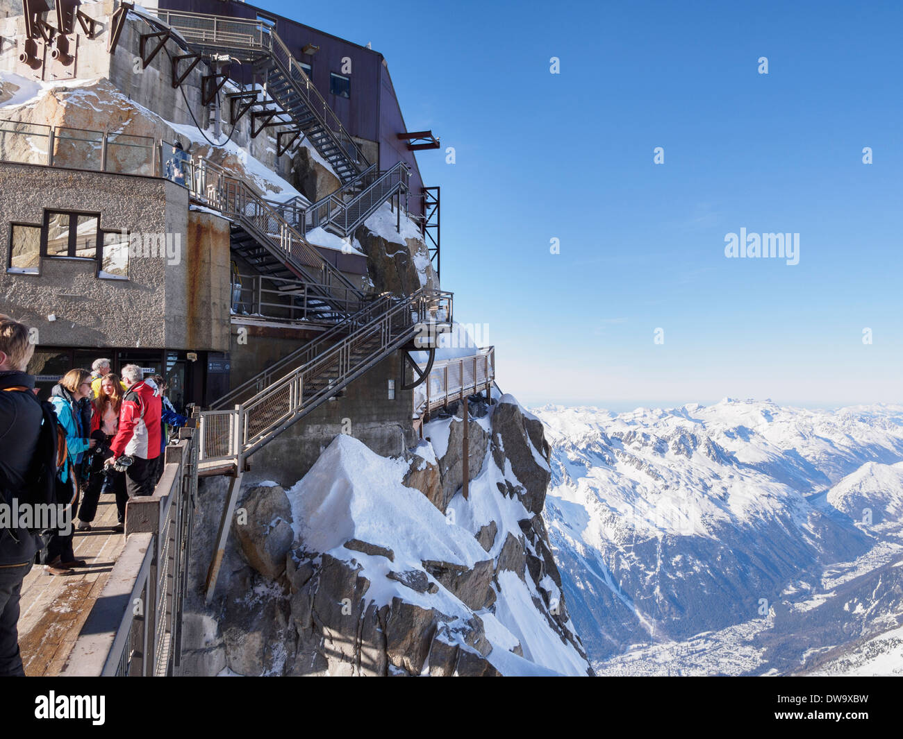 People on bridge viewing platform at Aiguille du Midi top téléphérique cable-car station. Chamonix-Mont-Blanc Rhone-Alpes France Stock Photo