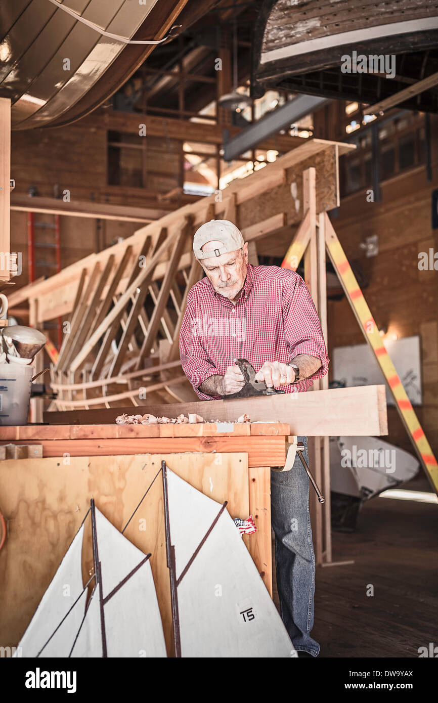 Senior man working on boat-building hobby Stock Photo