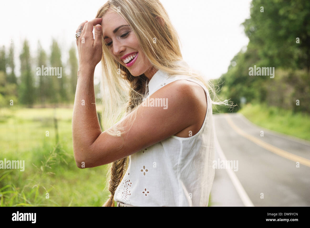Young woman standing on roadside Stock Photo