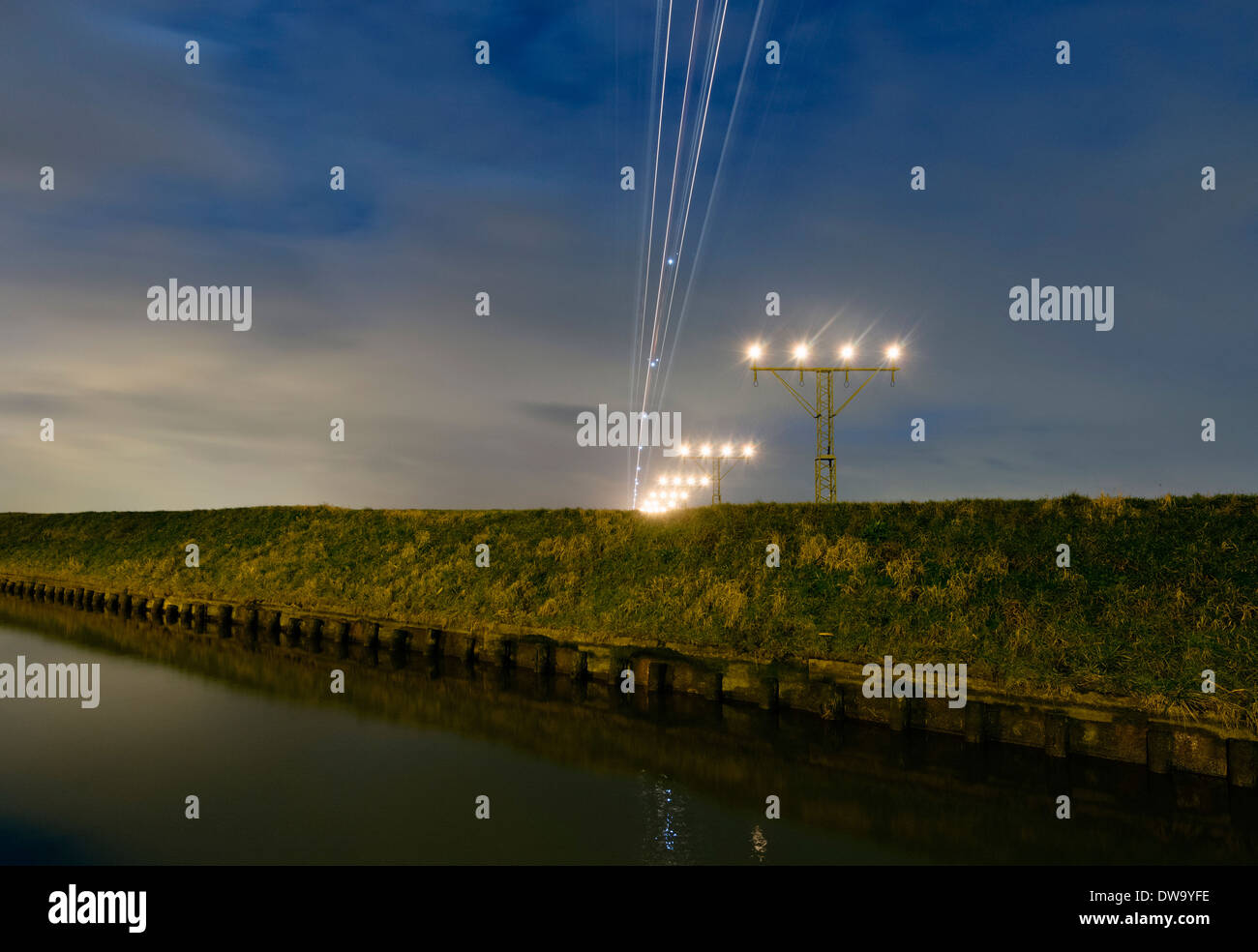 Night shot of airplane approaching runway Schiphol airport, Amsterdam, Netherlands Stock Photo