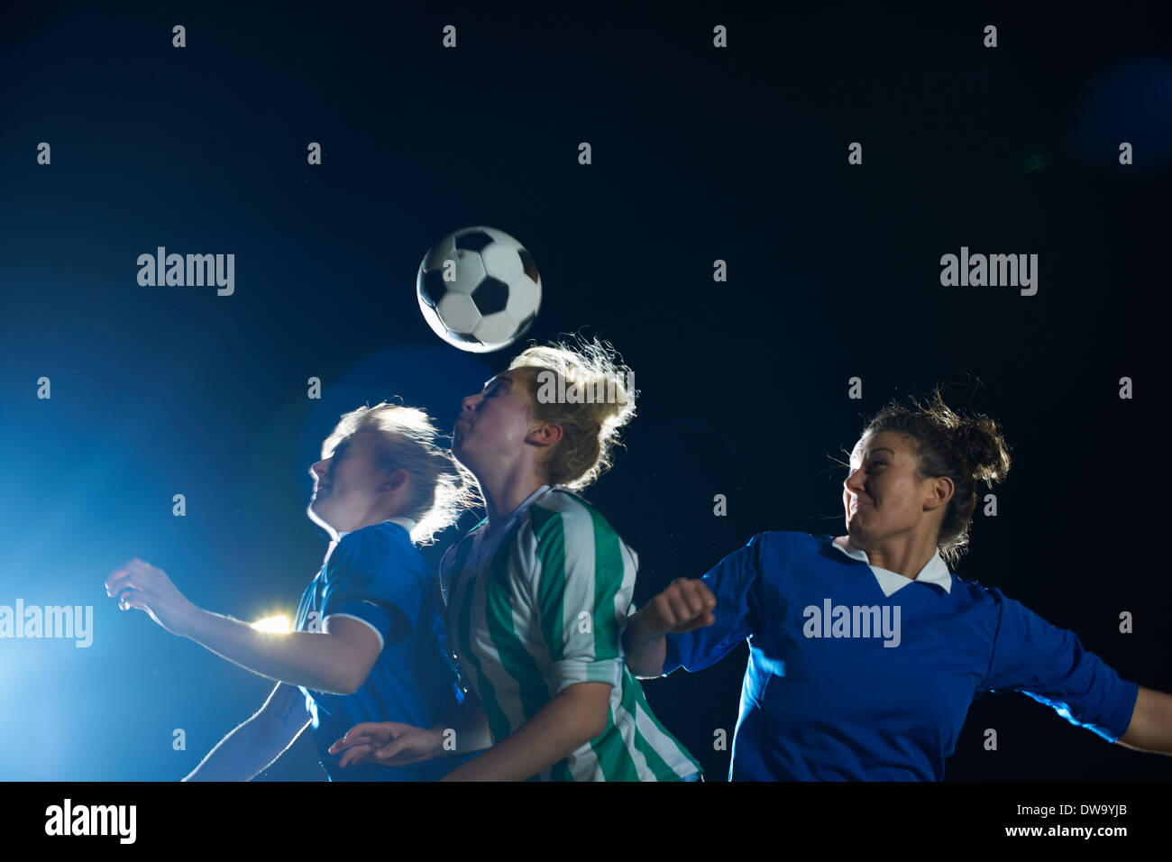 Female soccer players hitting ball with head Stock Photo Alamy