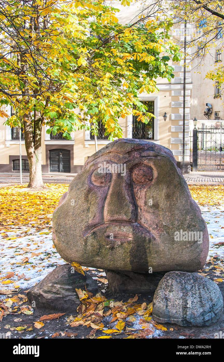 A pagan stone head at livu square in old town Riga. Stock Photo