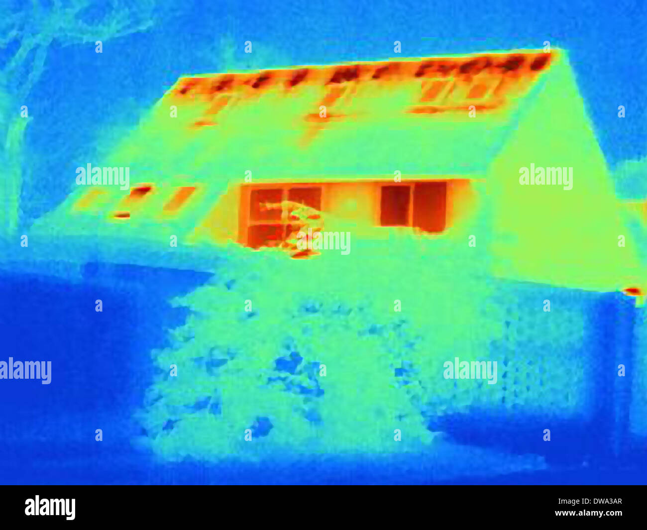 Thermal image of house, showing loss of heat due to poor loft insulation Stock Photo