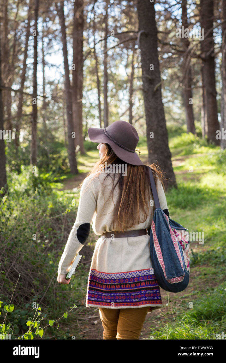 Young woman wearing hat in forest Stock Photo