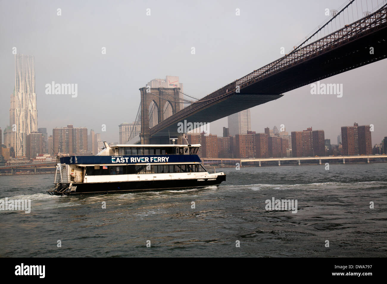 East river ferry under the Brooklyn bridge Stock Photo