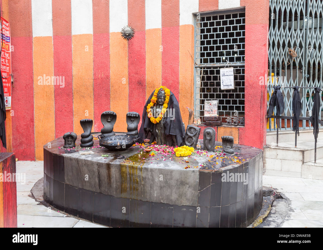 Altar in Hindu temple in New Delhi, India, with orange marigold garland