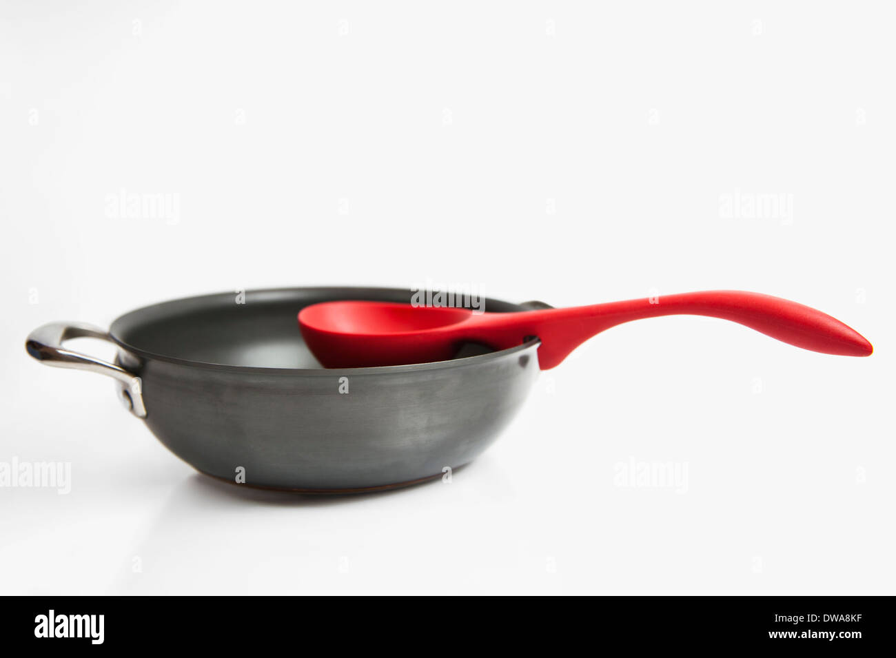 Pot and red spoon kitchenware Stock Photo