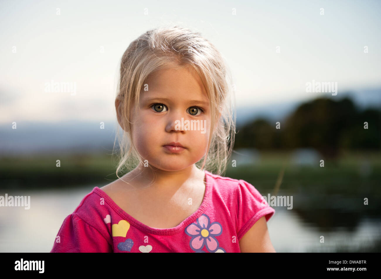 Cute toddler girl outdoors during sunset. Stock Photo