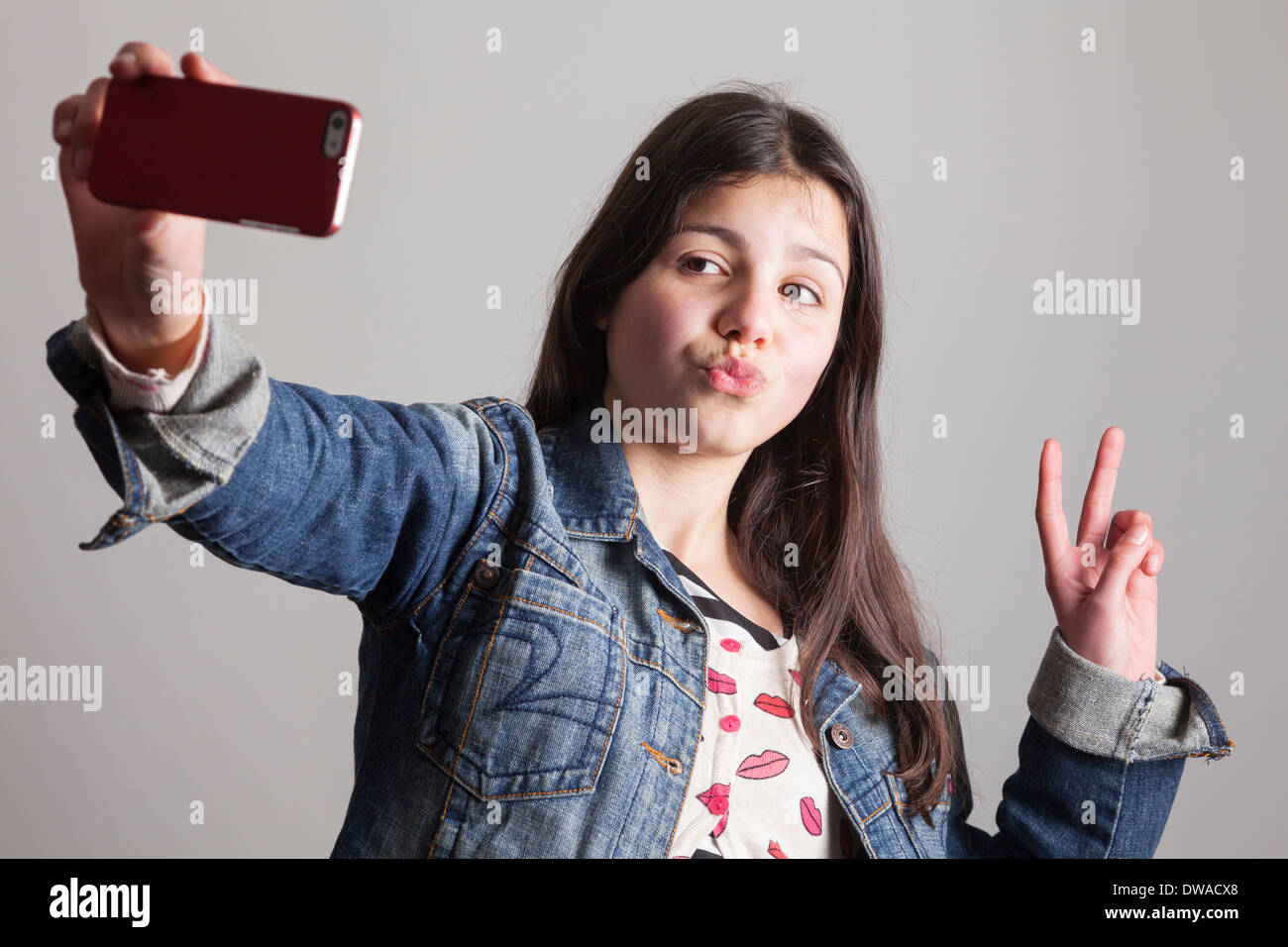 Teenage girl takes a selfie on camera phone Stock Photo