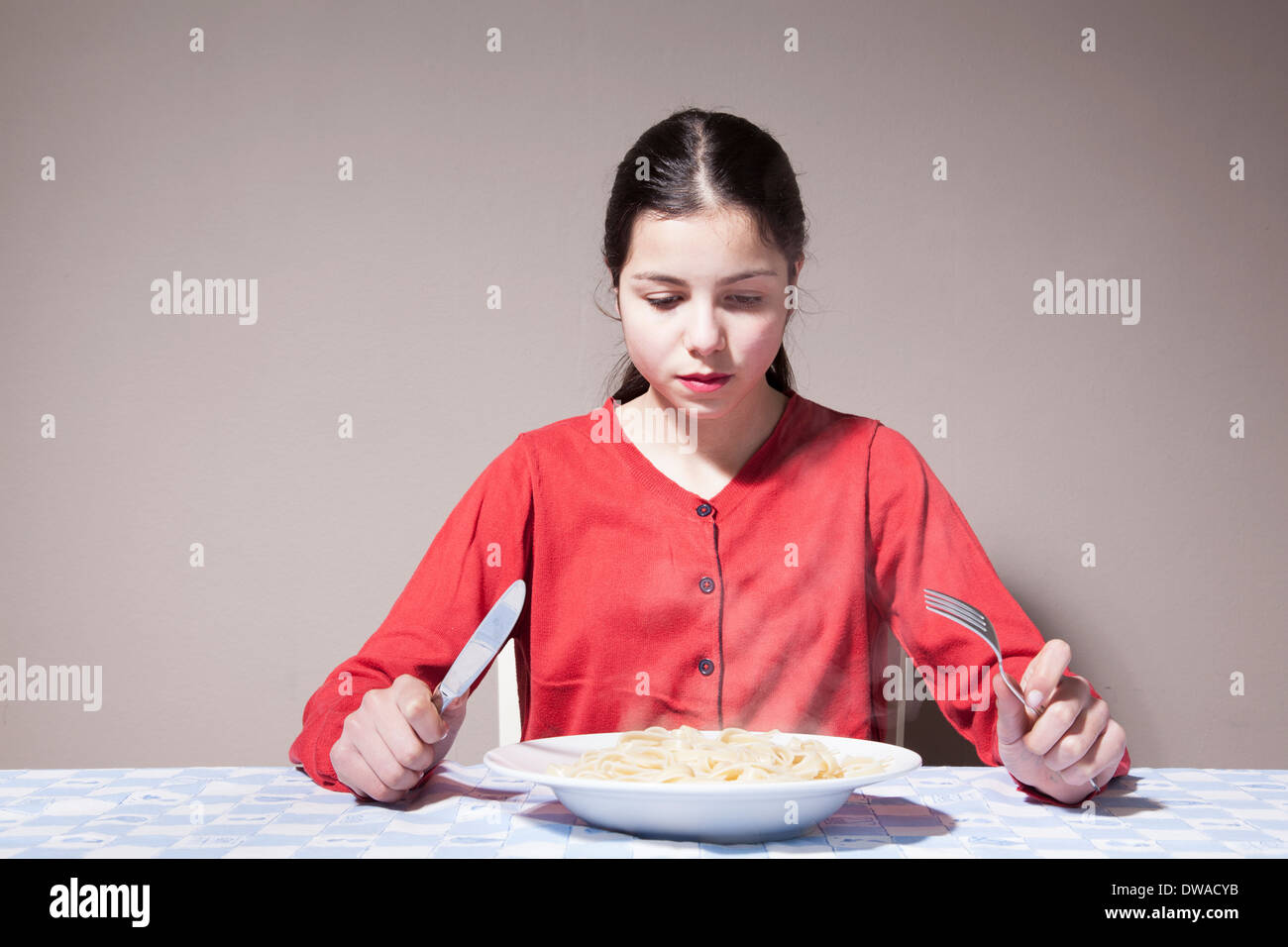 Teenage girl eating pasta Stock Photo