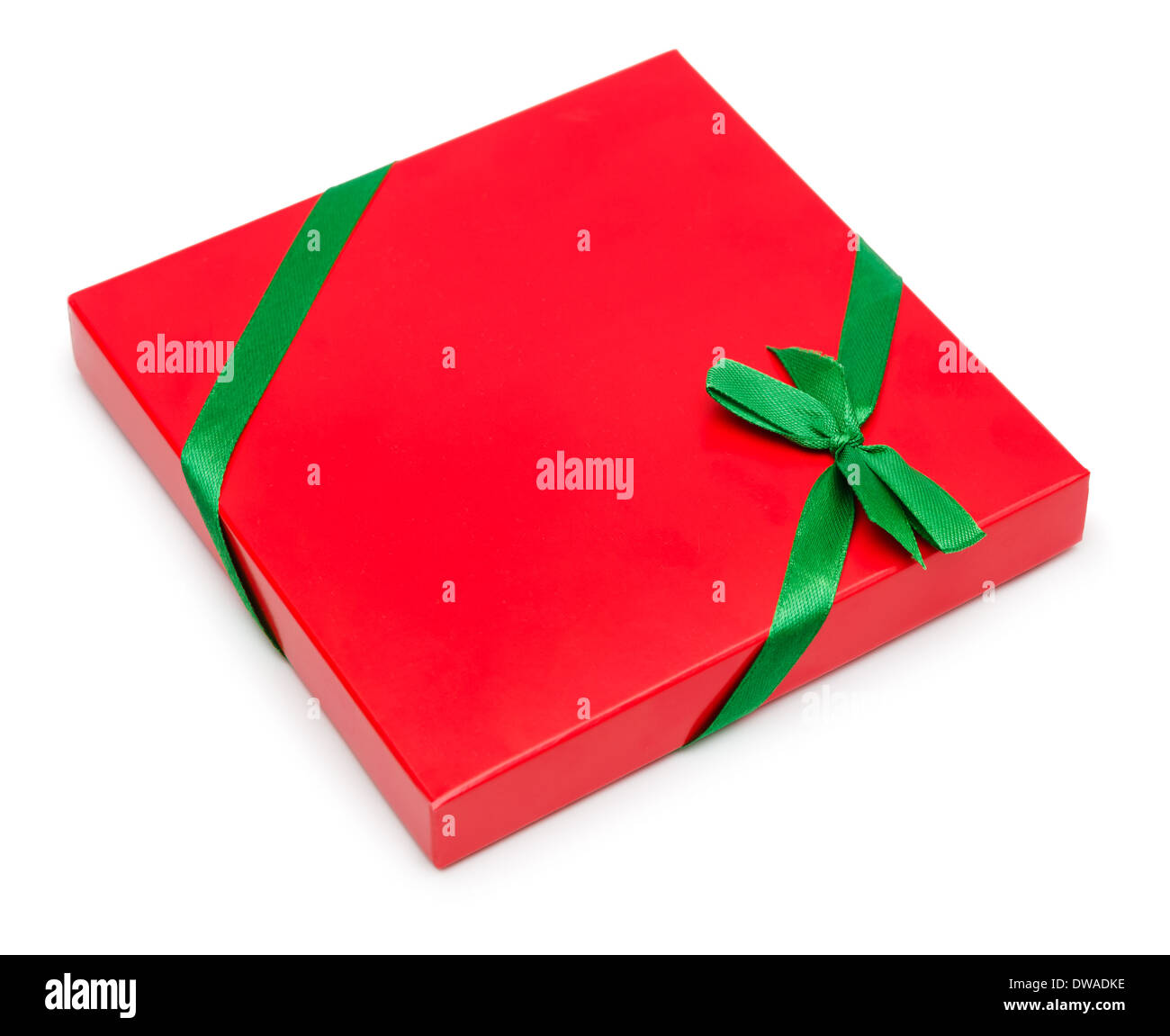 Red present box with green ribbon and bow isolated on white background, clipping path included. Stock Photo