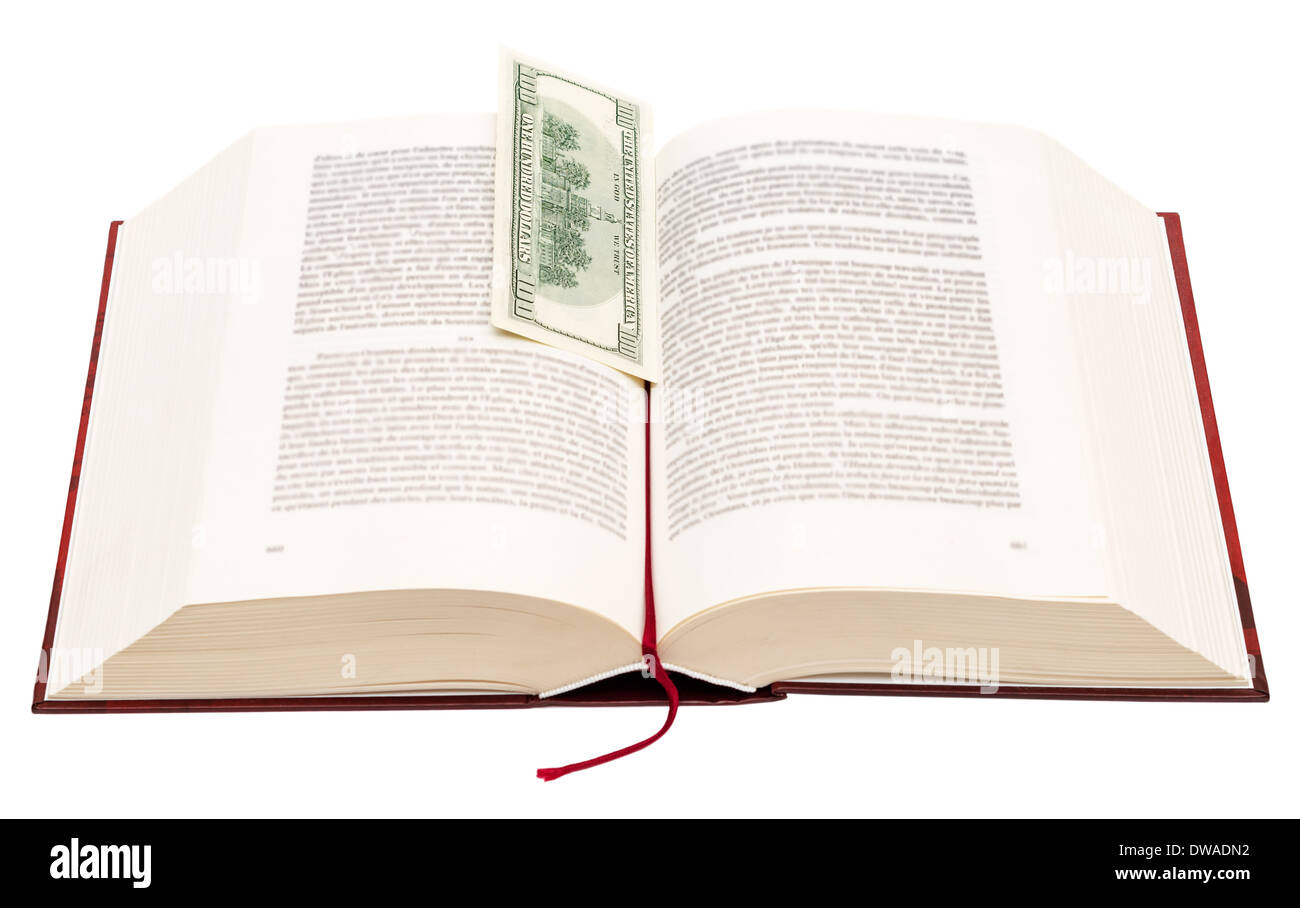 Book with bookmark. Hundred dollar bill sticking out of book, indicating value of book. Isolated on white background. Stock Photo