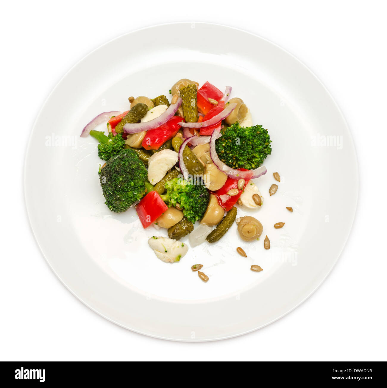 Broccoli salad with bell peppers, pickled cucumber, mushrooms and mozzarella. Isolated on white background. Stock Photo