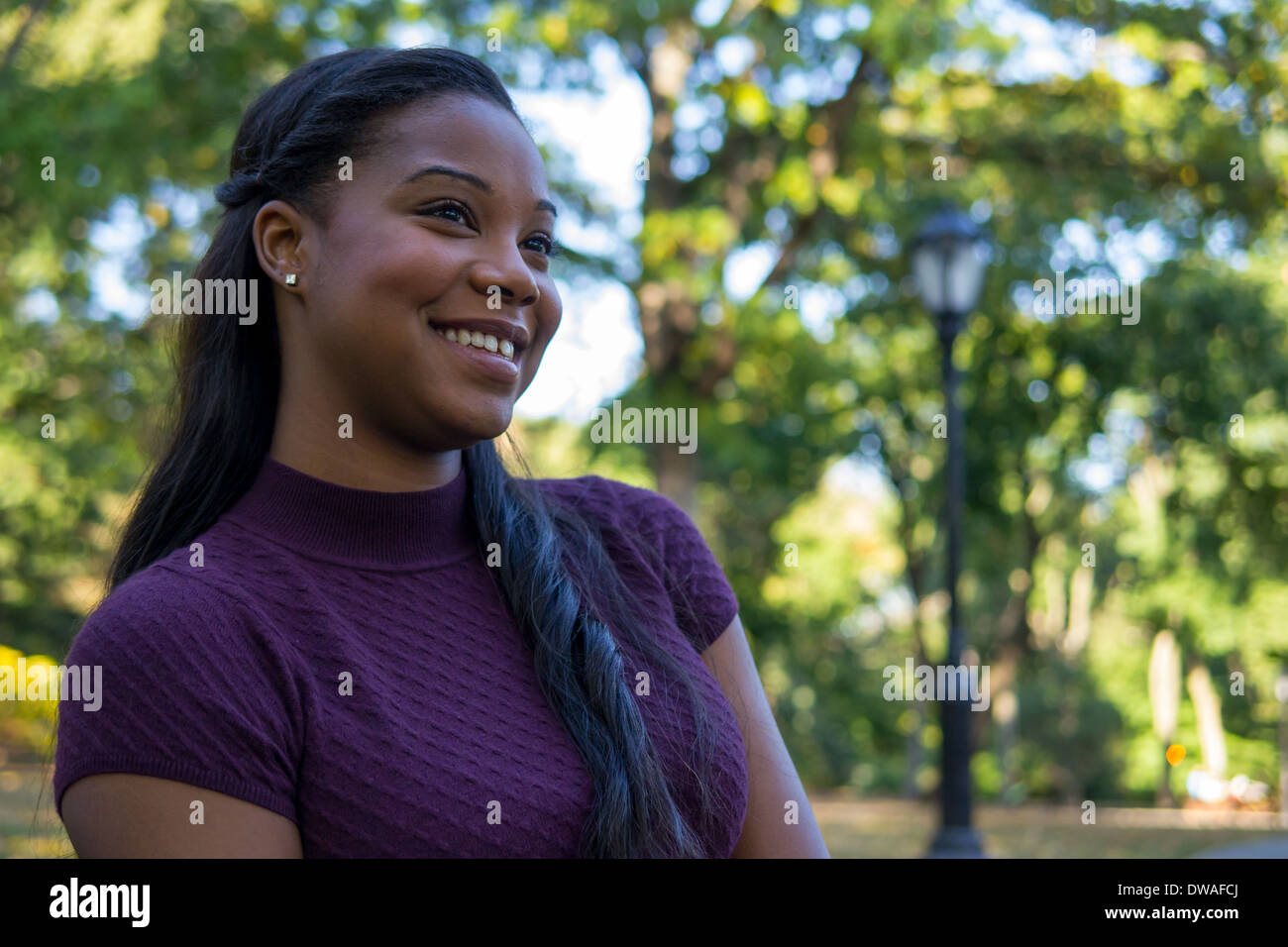 Smiling black woman in purple hi-res stock photography and images - Alamy