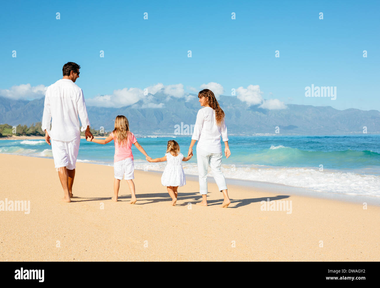 Happy family running on beach hi-res stock photography and images - Alamy