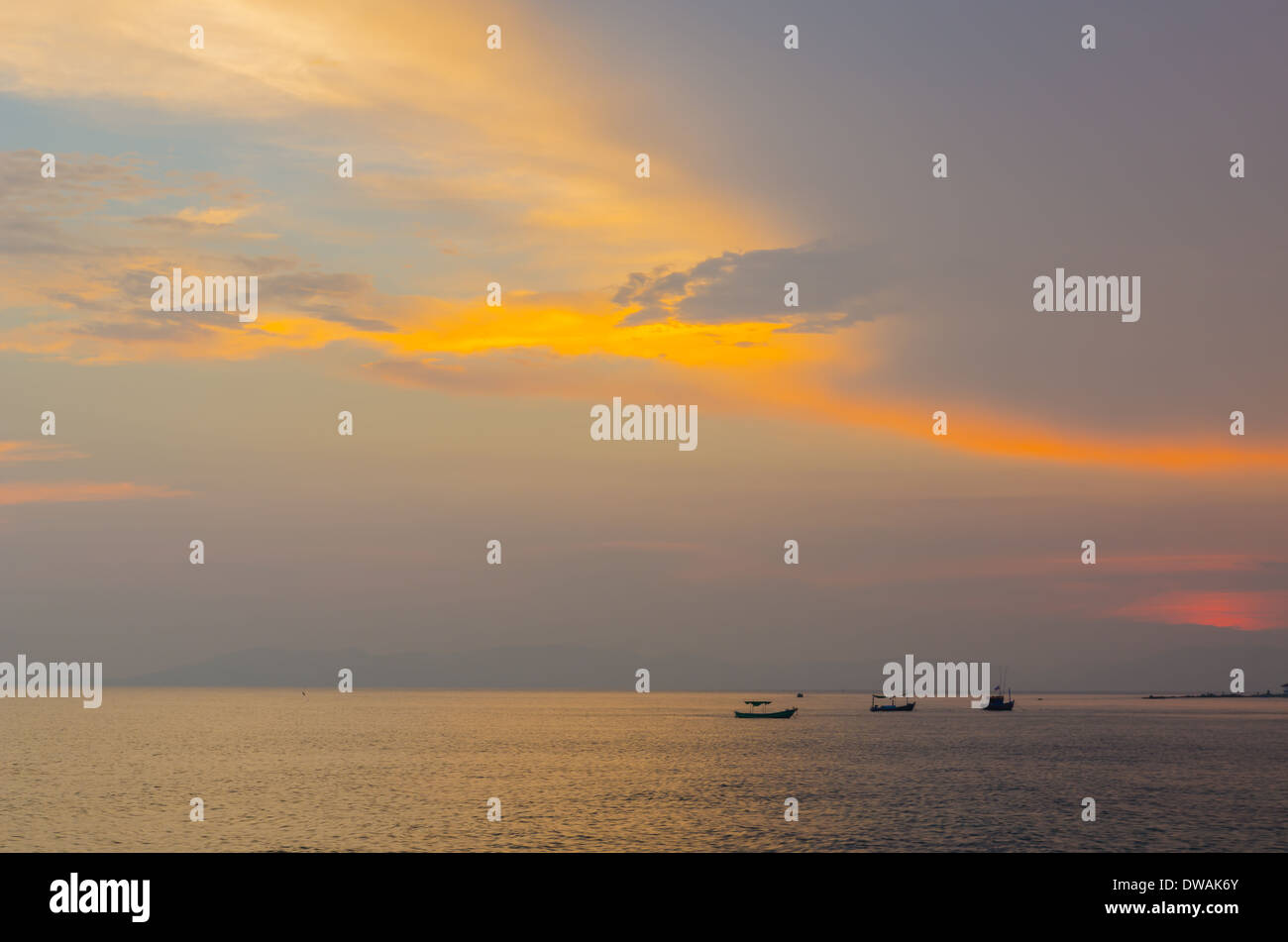 Small fishing boats anchor near bay in the evening Stock Photo