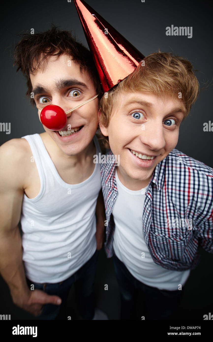 Two funny guys looking at camera and smiling crazily Stock Photo