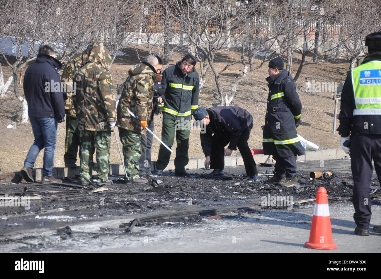 Jilin, China . 05th Mar, 2014. Rescuers investigate the site of a bus fire in Jilin, northeast China's Jilin Province, March 5, 2014. Ten people were killed and another 17 injured in a bus fire Wednesday morning when the bus was traveling along a street in Jilin. Forty-three people were on board when the fire broke out. Credit:  Xinhua/Alamy Live News Stock Photo