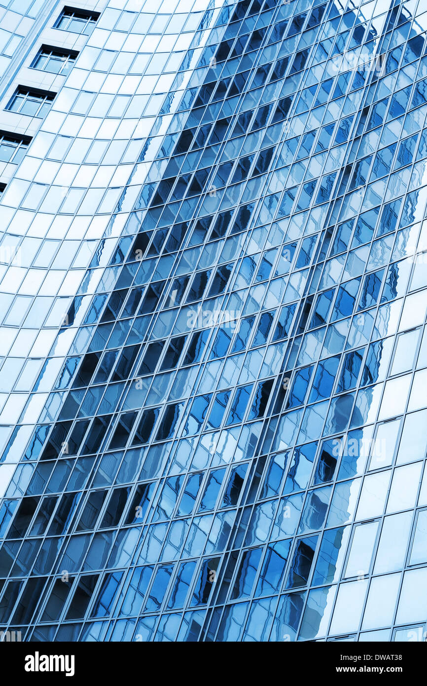 Modern skyscraper blue windows glass wall with reflections Stock Photo