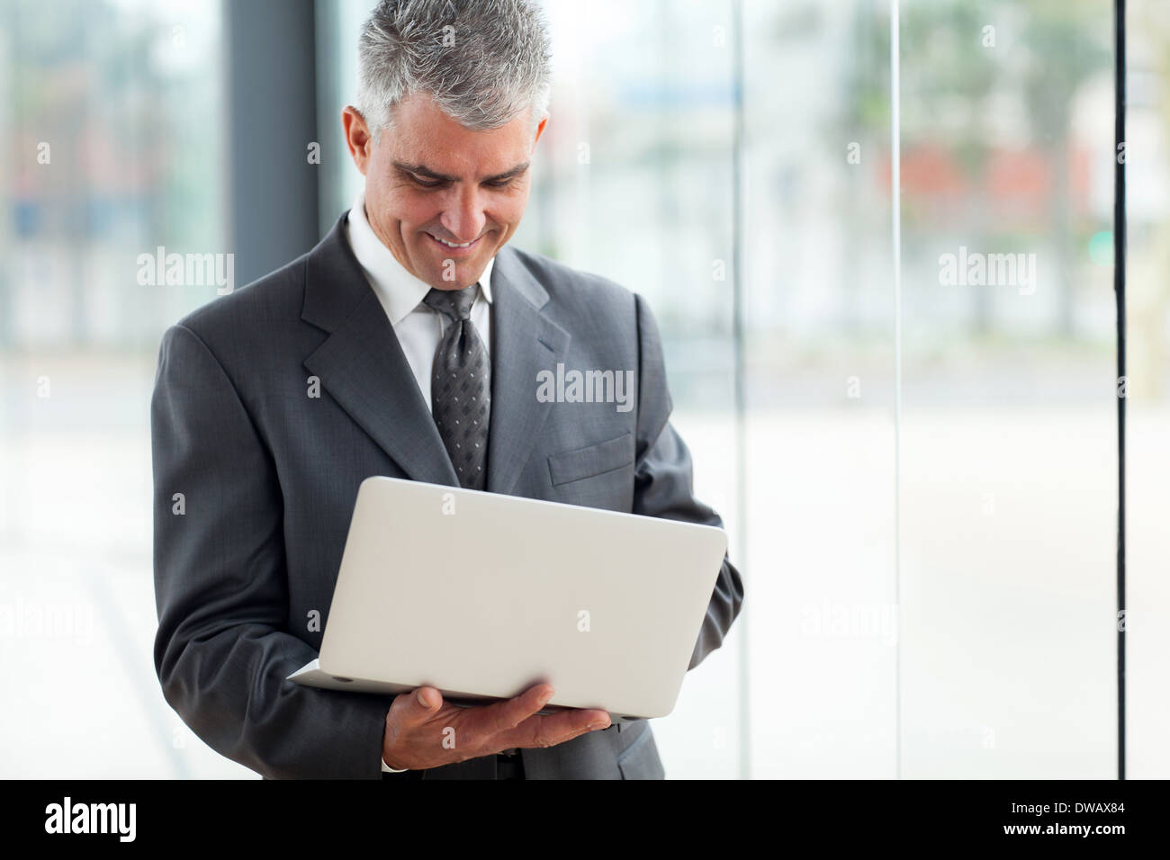 happy senior businessman using laptop computer at work Stock Photo