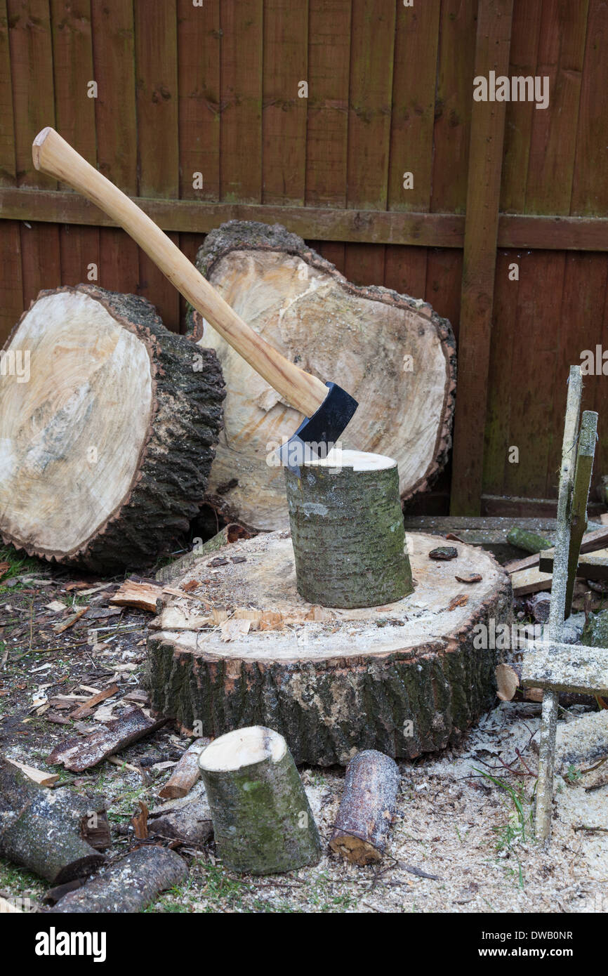 An axe in a piece of wood on a chopping block for making firewood