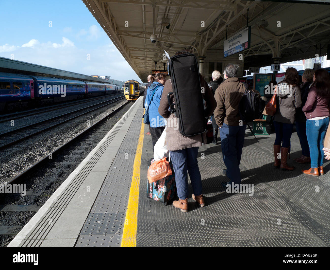 Rail passengers waiting for train on the platform at Cardiff Central Railway Station Wales UK  KATHY DEWITT Stock Photo