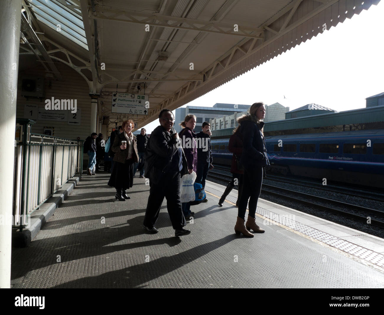 Rail passengers waiting for train on the platform at Cardiff Central Railway Station (Cardiff Train Station) in Wales UK  KATHY DEWITT Stock Photo
