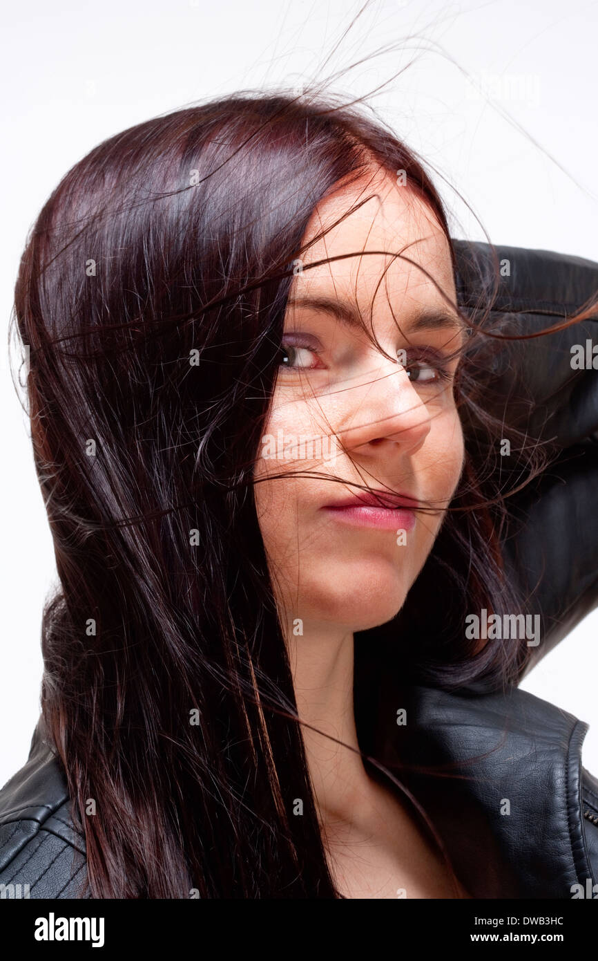 Portrait of a Young Woman in Leather Jacket - Isolated on Gray Stock Photo