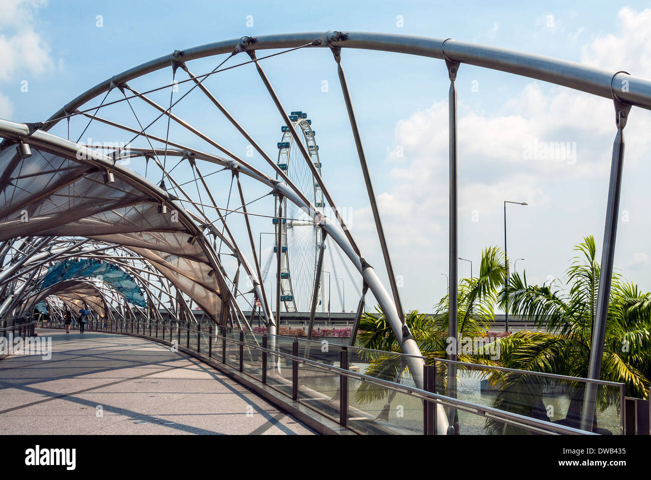 The Helix Bridge with view to Singapore Flyer, Singapore Stock Photo