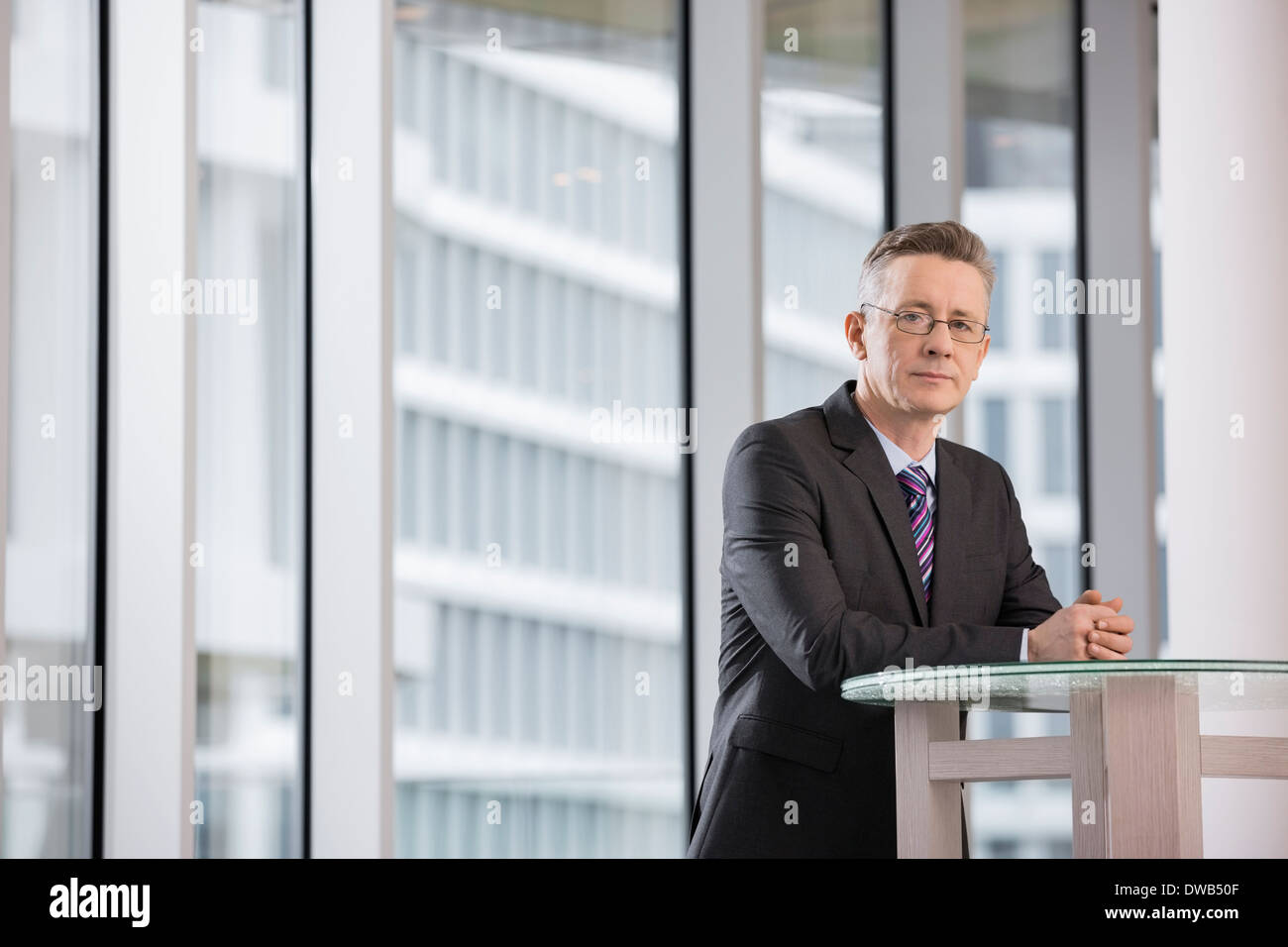 Portrait of confident businessman standing in office Stock Photo
