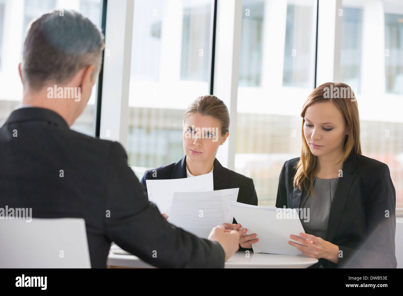 Business people discussing paperwork in office cafeteria Stock Photo ...
