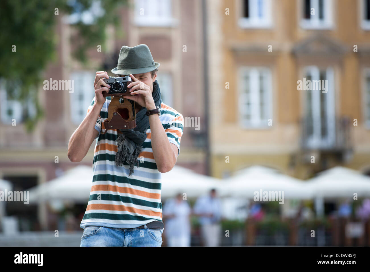 Young man photographing through vintage camera outdoors Stock Photo