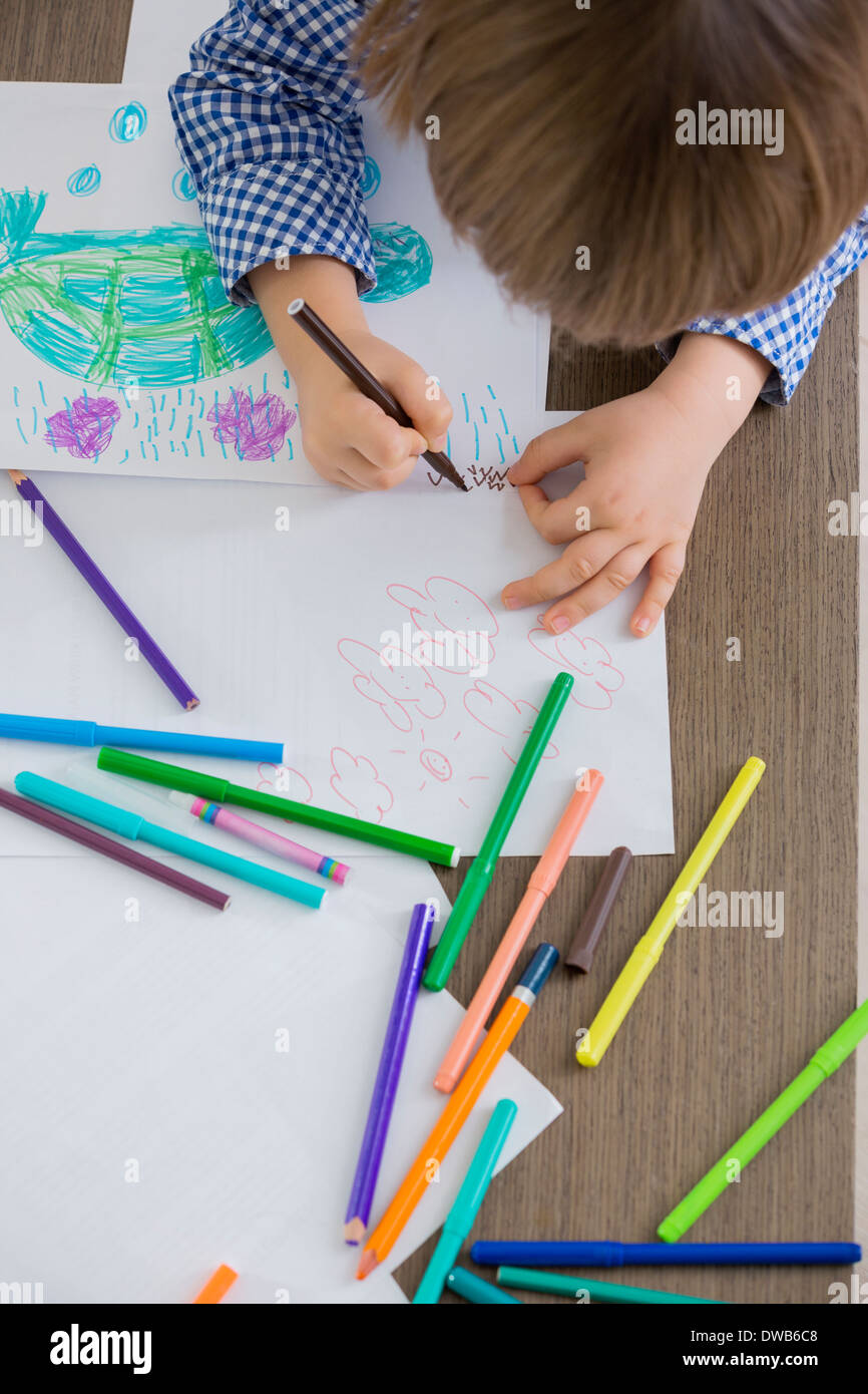 Directly above shot of boy drawing at home Stock Photo