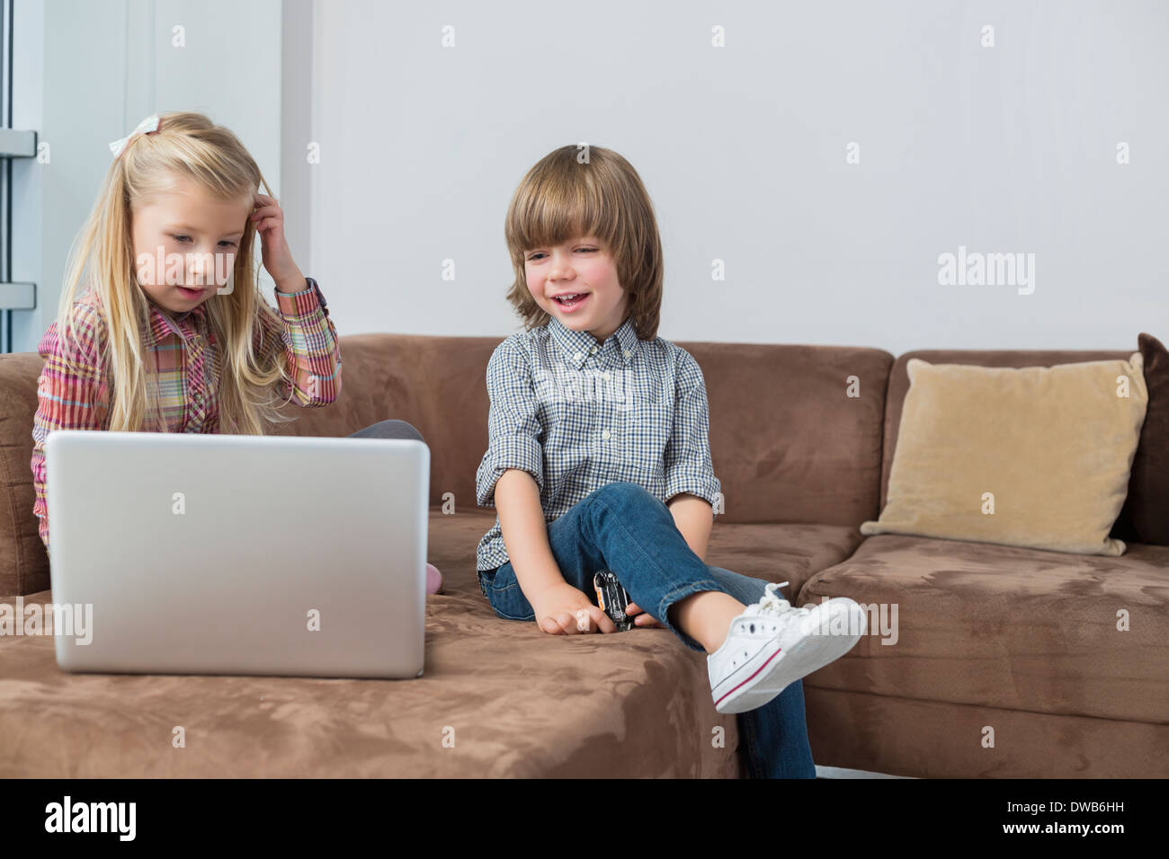 Brother sister sitting on sofa hi-res stock photography and images - Alamy
