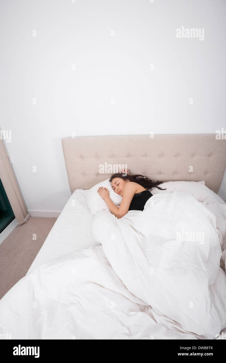 High angle view of young woman sleeping in bed Stock Photo