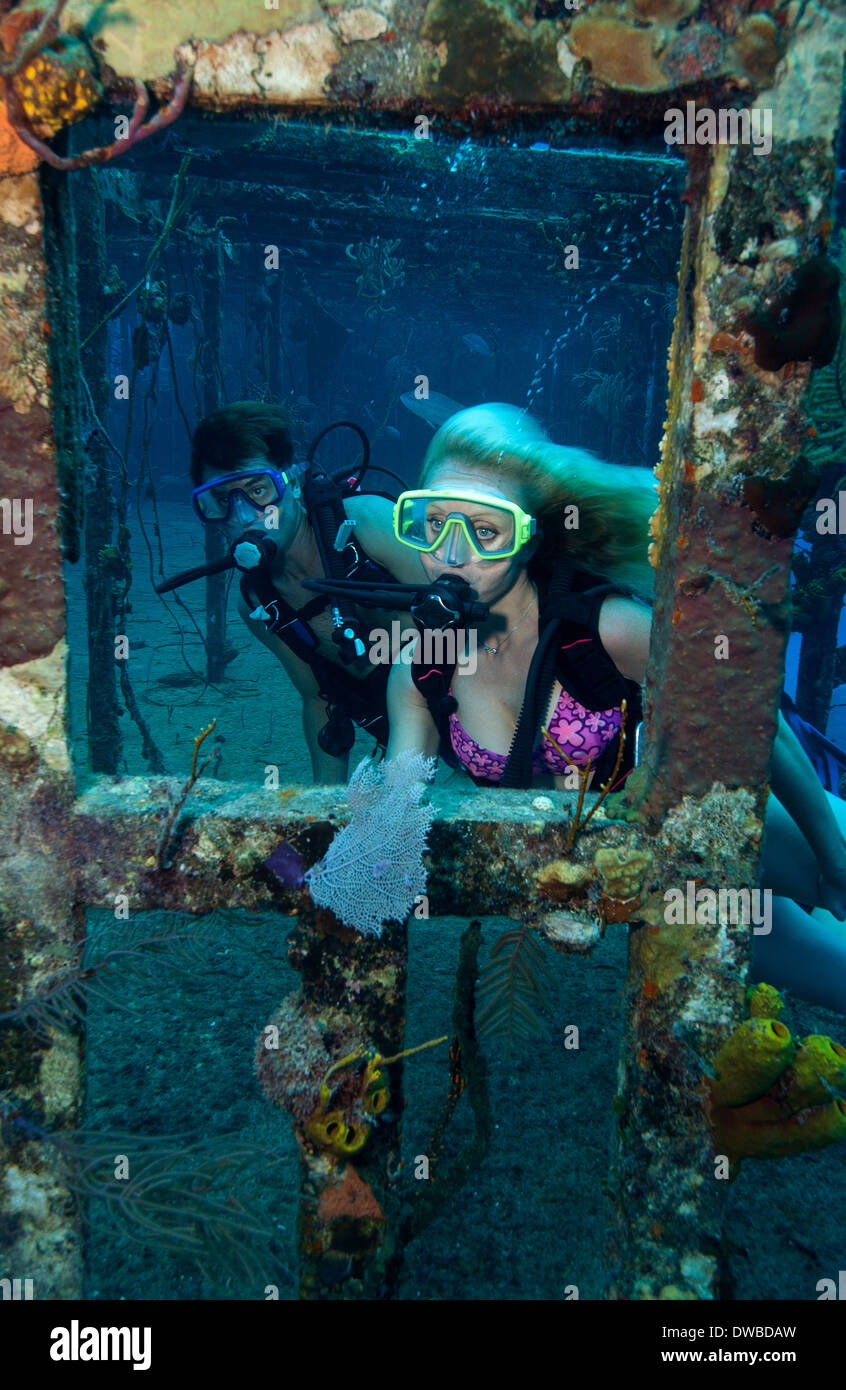 Scuba divers on shipwreck. Stock Photo