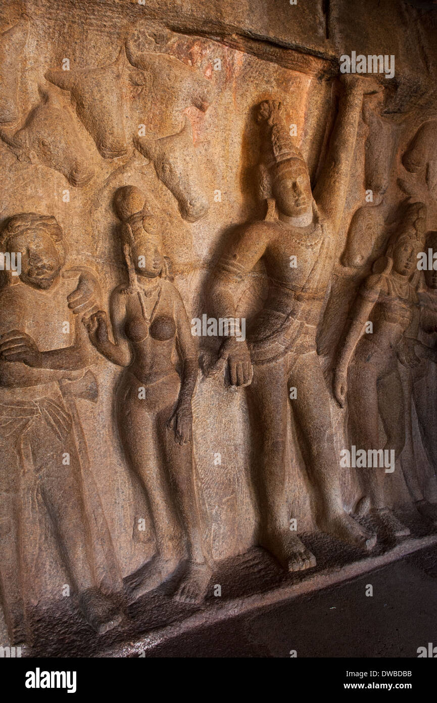 India Tamil Nadu Mamallapuram Mahishasuramardini Cave Temple Goddess Durga bas relief rock sand stone carving figures detail dancing girls men cattle Stock Photo