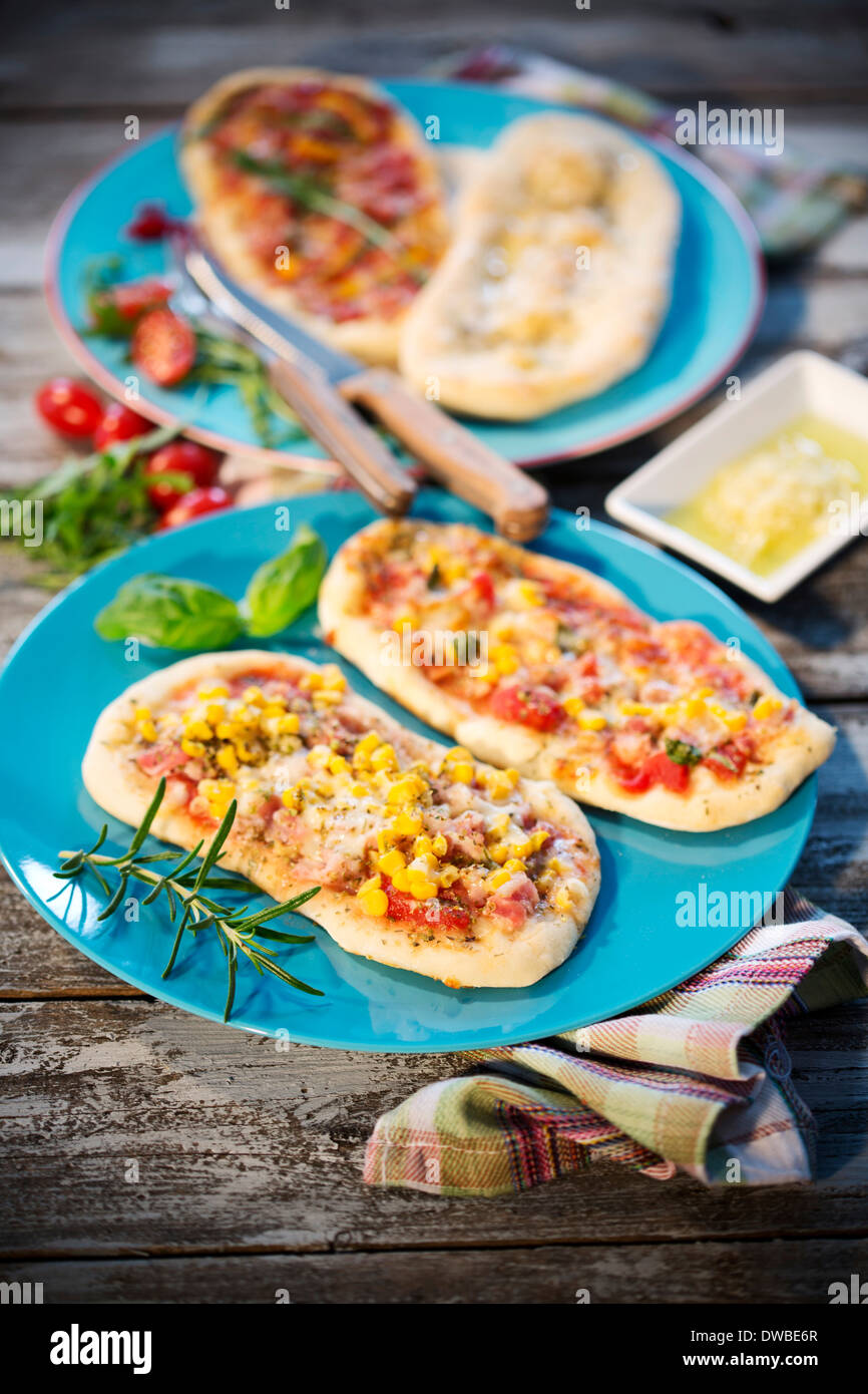 Pizza rolls, with ham, salami, mozzarella, tomato, rucola, maize and