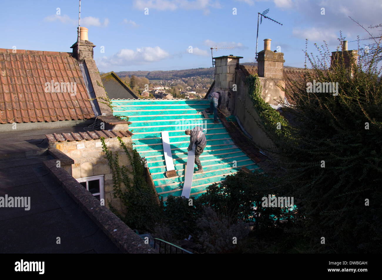 Two men roofing a grade two listed terraced cottage in Batheaston near Bath Somerset England UK Stock Photo