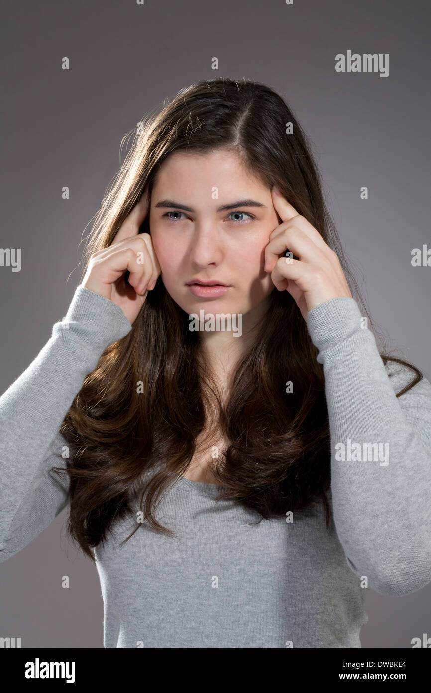 Young woman temples finger hi-res stock photography and images - Alamy