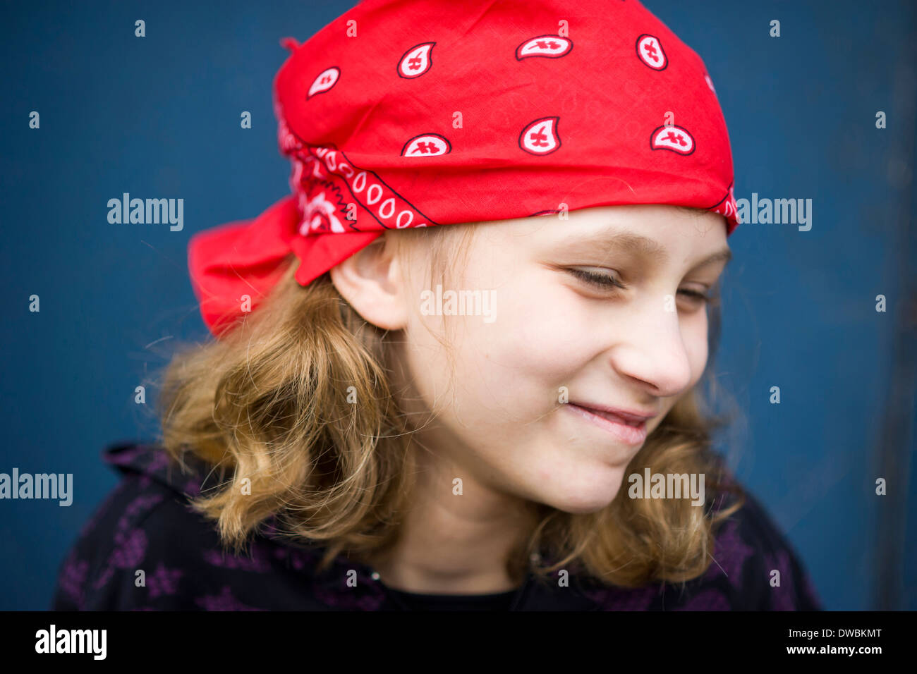 Portrait of smiling girl with red headscarf Stock Photo